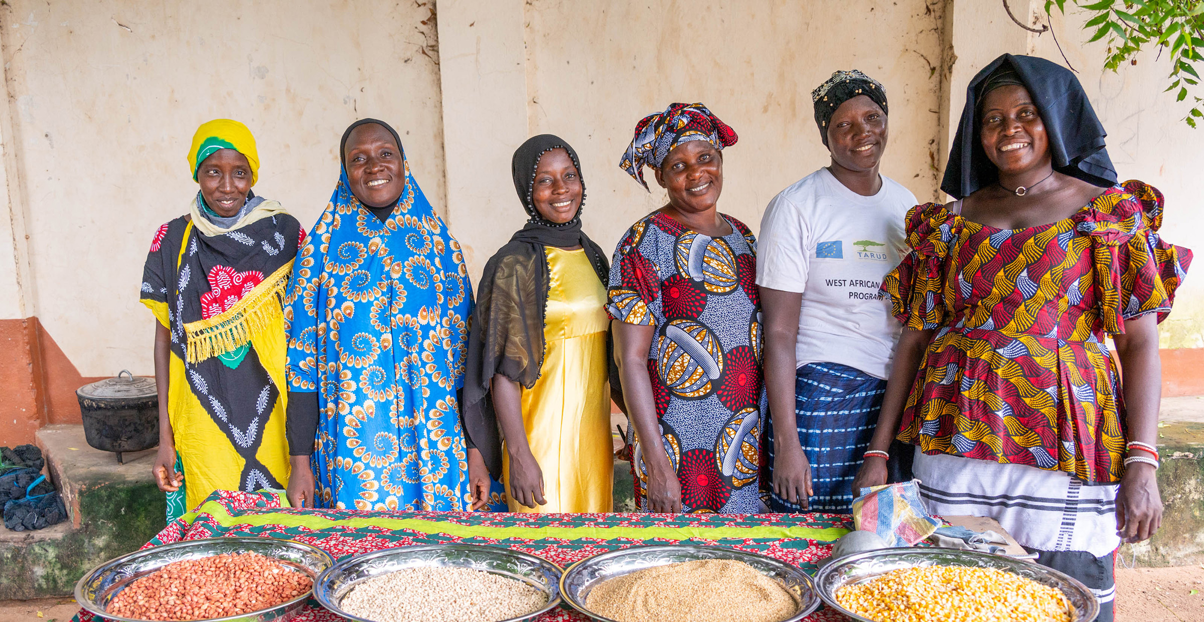 Members of the Jahaur Yanpi Cooperative show the groundnuts, millets, cowpea and maize they will use to make a legume-cereal based complementary porridge.